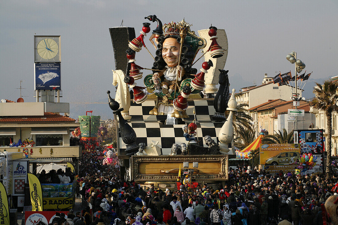 A float representing the Italian businessman and politician Silvio Berlusconi surrounded by a huge crowd in the streets of Viareggio.