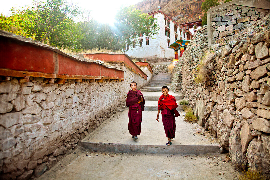 India, Jammu and Kashmir, Ladakh. Two novice monks walking to The Drukpa Kagyud Primary School. The school is part of Hemis Buddhist Monastery located 45 kilometers from Leh in Ladakh, Northern India.