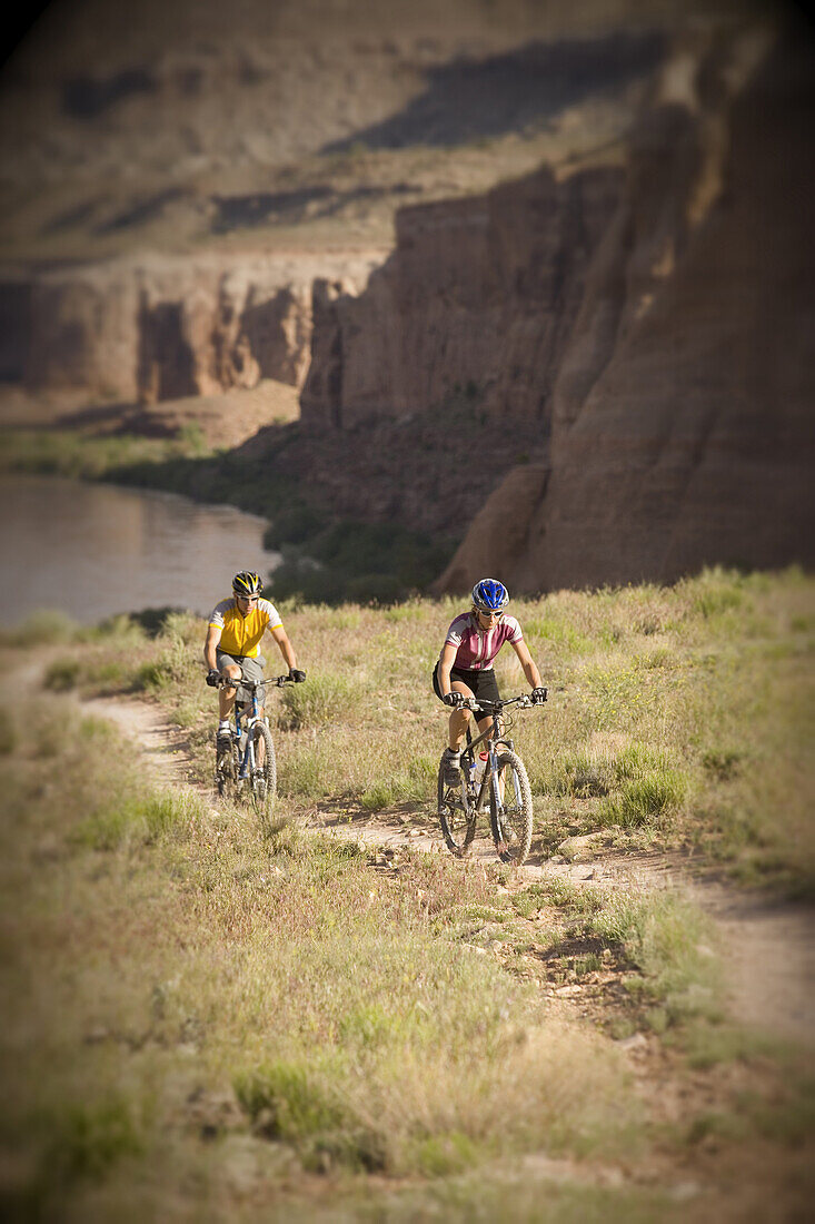Mountain biker couple riding Horse Thief Bench Trail, near Fruita, Colorado.