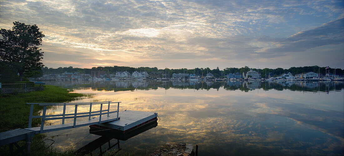 ROWAYTON, CT - JUNE 13: Morning clouds reflect in Rowayton Harbor as the sun just crests the horizon. Rowayton, a waterfront community of Norwalk, CT, is home to many sailors and fishermen and is about 45 miles up Long Island Sound from New York City.