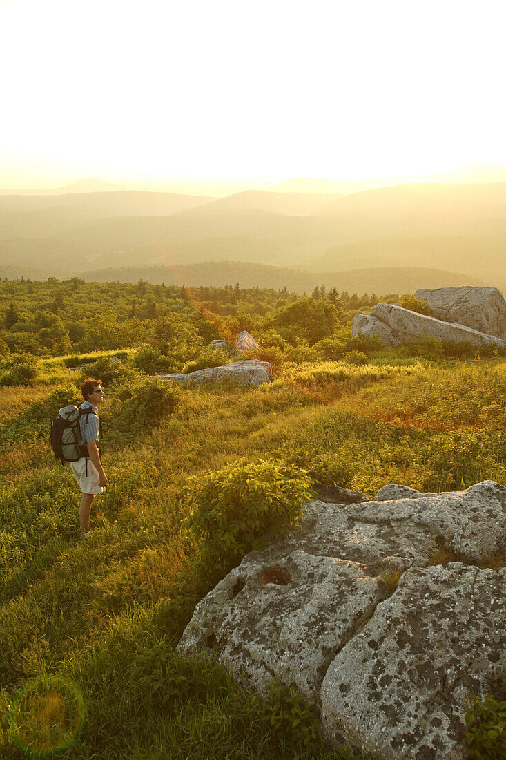 Harrison Shull checks out the sunset view from the Whispering Pines trail on top of Spruce Knob WV's highest point 4863, near Circleville, WV.