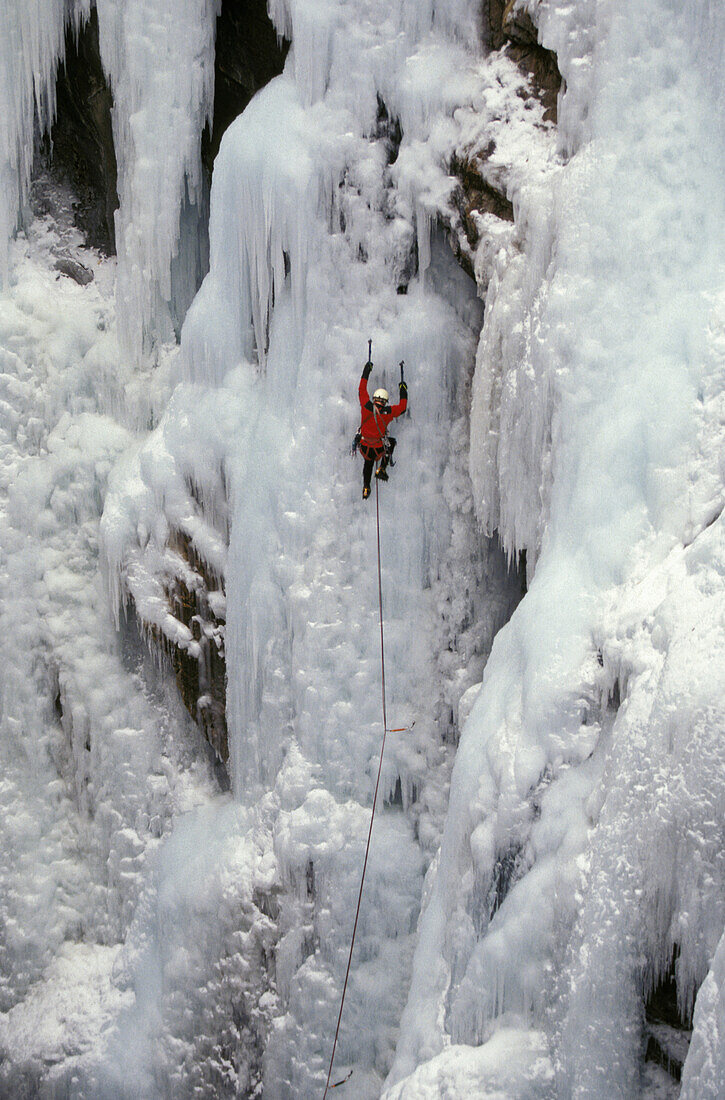 Steve Giddings makes his way up a frozen waterfall at the Ouray Ice Festival in Ouray, Colorado. Ice climbers require ice axes, crampons, rope and harness as well as a great deal of balance and focus. The Ouray Ice Festival is located in the Uncompahgre G