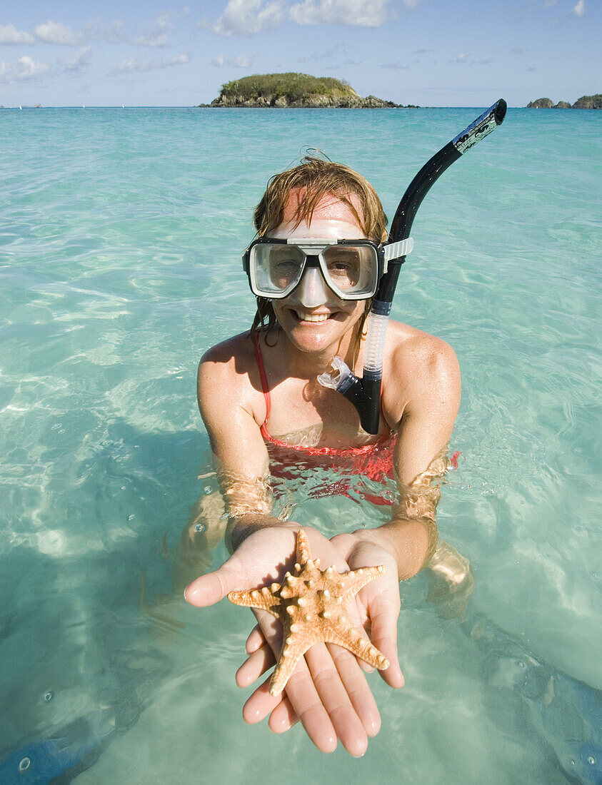 Cree Bol holding a starfish while snorkeling in Virgin Islands National Park, St. John, on April 18, 2006.