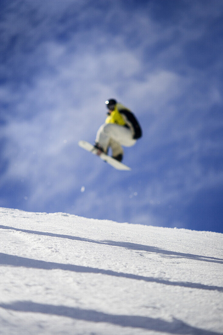 Toronto , ON -  March 11 : A freestyle snowboarder gets big air as he grabs his board.  Photo by Paul Giamou / Aurora Photos 