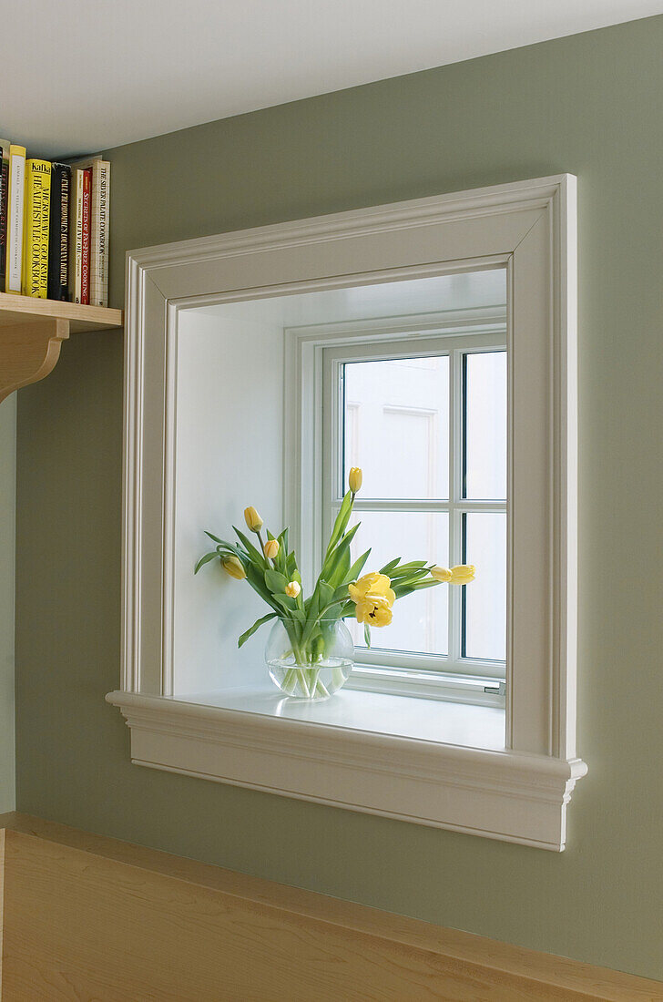 A vase filled with yellow tulips sits on a windowsill in a home in Rhode Island. Tom Hopkins/Aurora