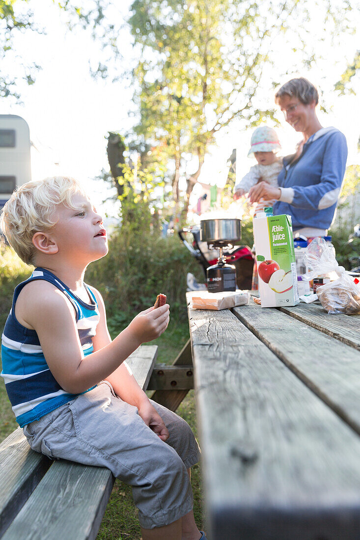 Family preparing dinner at campground, Marielyst, Falster, Denmark