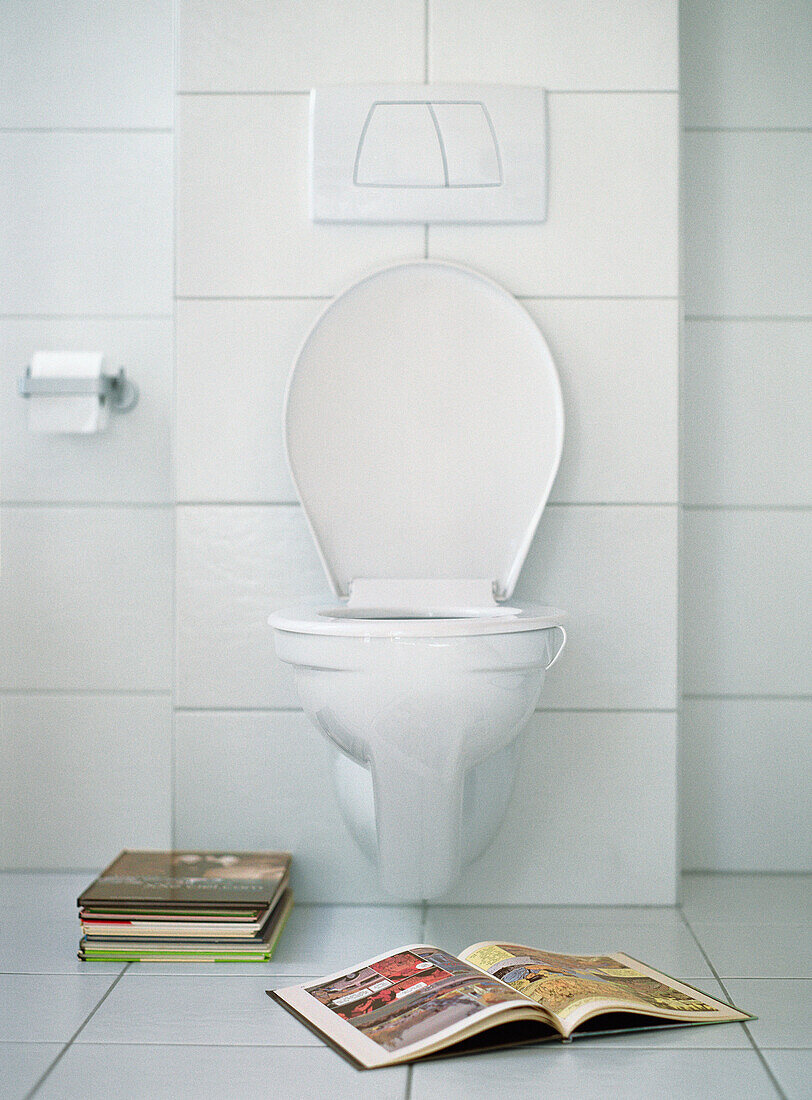Open book in front of toilet