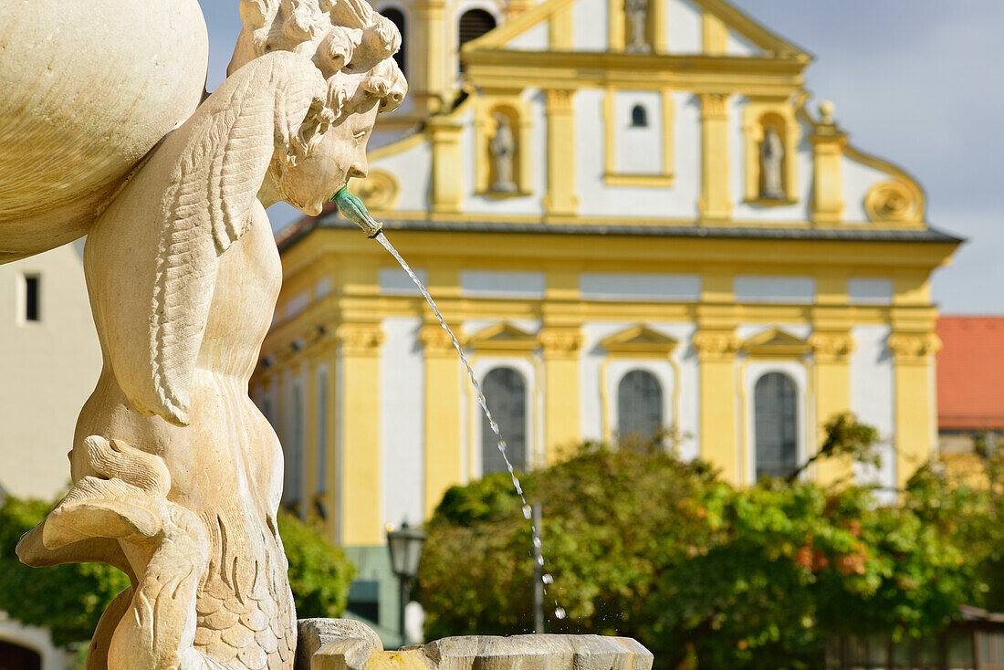Fountain at Kapellplatz, monastery of St. Magdalene in background, Altoetting, Upper Bavaria, Germany