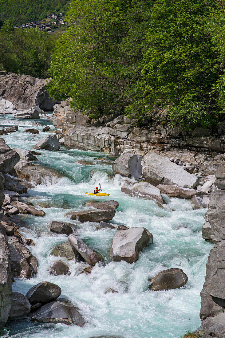 Kayaker on the crystal clear waters of the Verzasca, Ticino, Switzerland