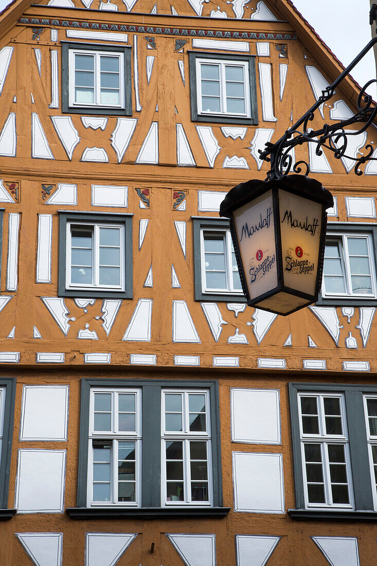 Maulaff bar sign lamp and timber frame building in the old town, Aschaffenburg, Franconia, Bavaria, Germany