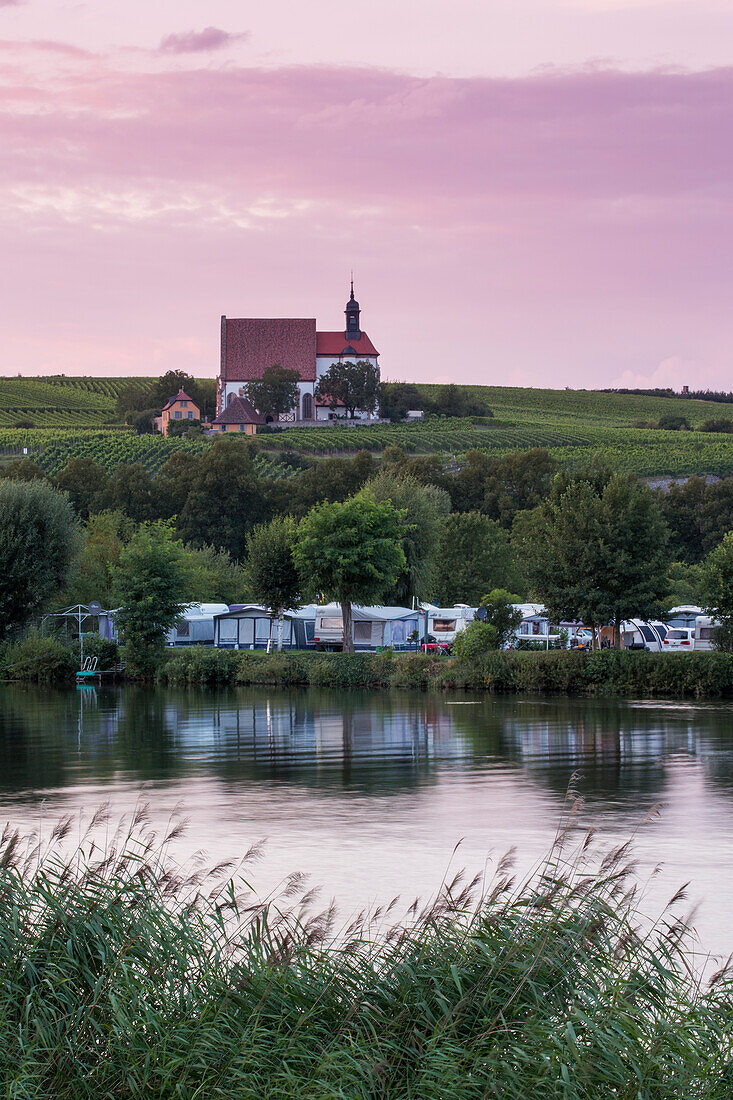 Camping site along the Main river and Maria im Weingarten pilgrimage church at sunset, Volkach, Franconia, Bavaria, Germany