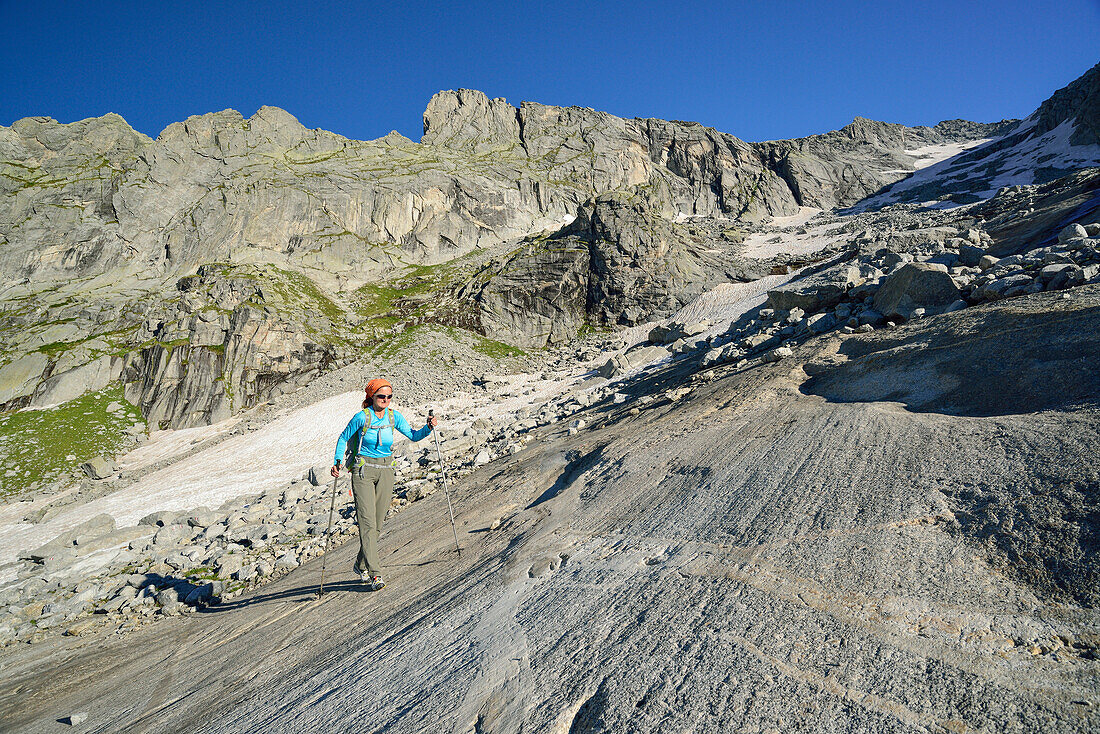 Woman hiking on rock slab, Sentiero Roma, Bergell range, Lombardy, Italy