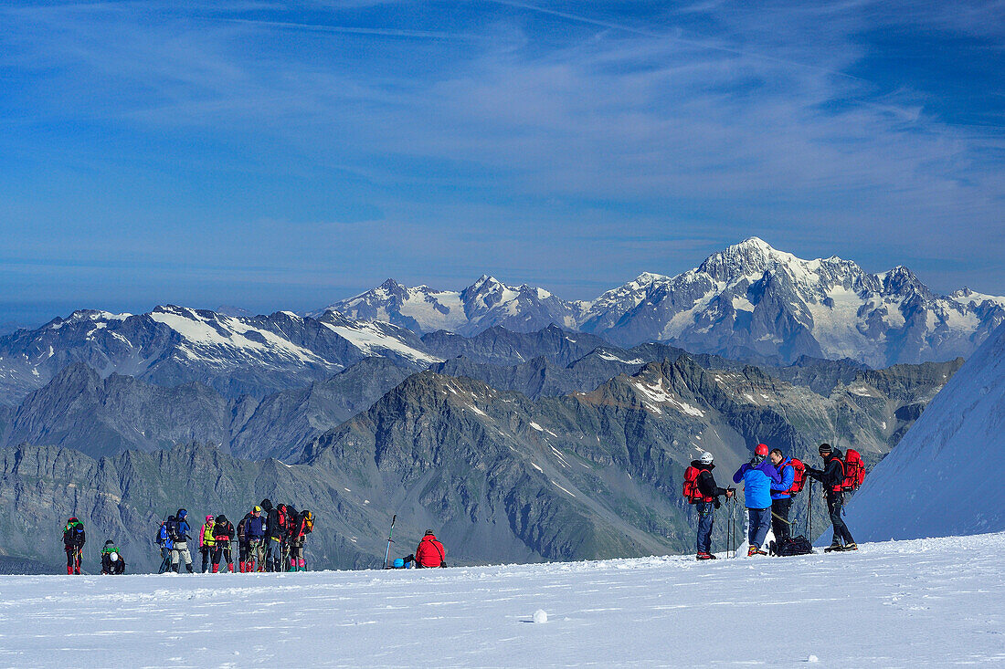 Several groups of persons standing on glacier of Gran Paradiso, Gran Paradiso, Gran Paradiso Nationalpark, Graian Alps range, valley of Aosta, Aosta, Italy