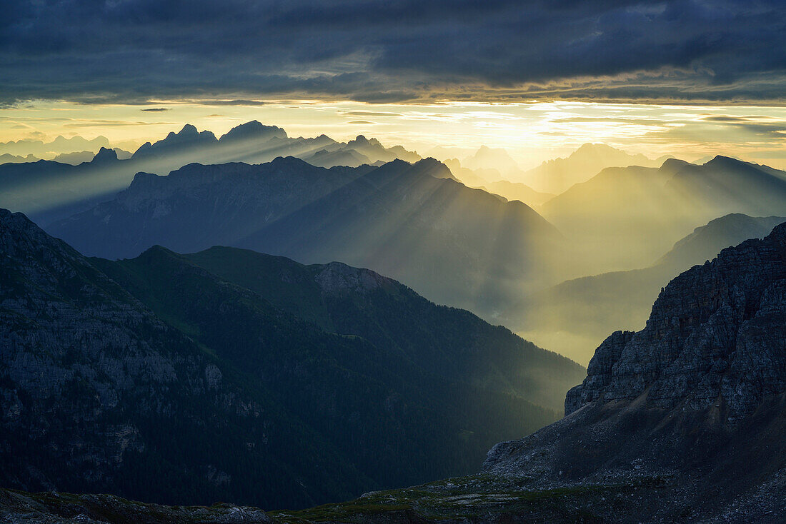 God beams over Dolomites with Marmolada, Antelao, Pelmo and Civetta, Rifugio Torre di Pisa, Latemar range, Dolomites, UNESCO world heritage Dolomites, Trentino, Italy