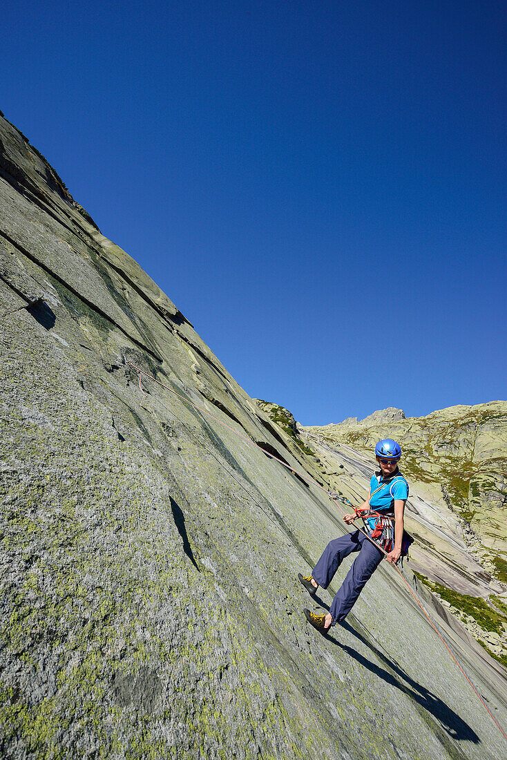 Woman climbing rappelling down Azalee … License image  