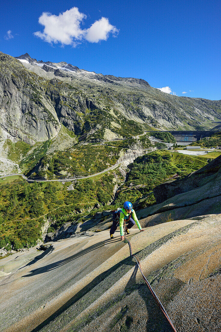 Woman climbing on granite slab, Sector Crow, Grimsel pass, Bernese Oberland, Switzerland