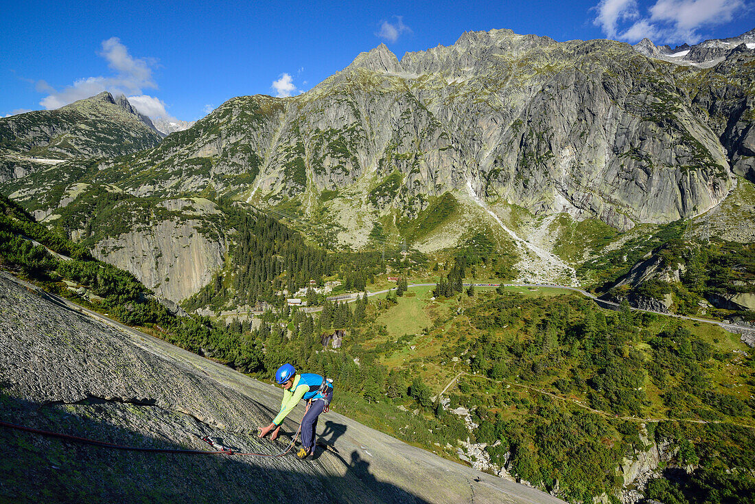 Woman climbing on granite slab, Sector Crow, Grimsel pass, Bernese Oberland, Switzerland