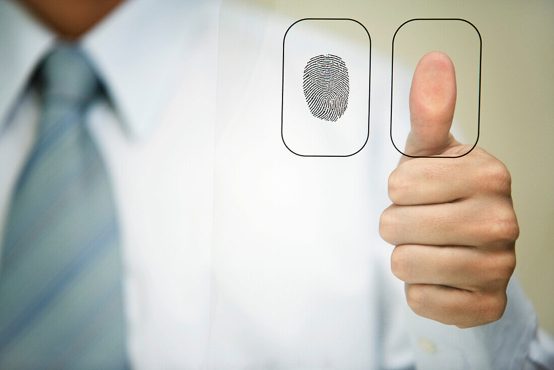 Man pressing thumb to fingerprint reader