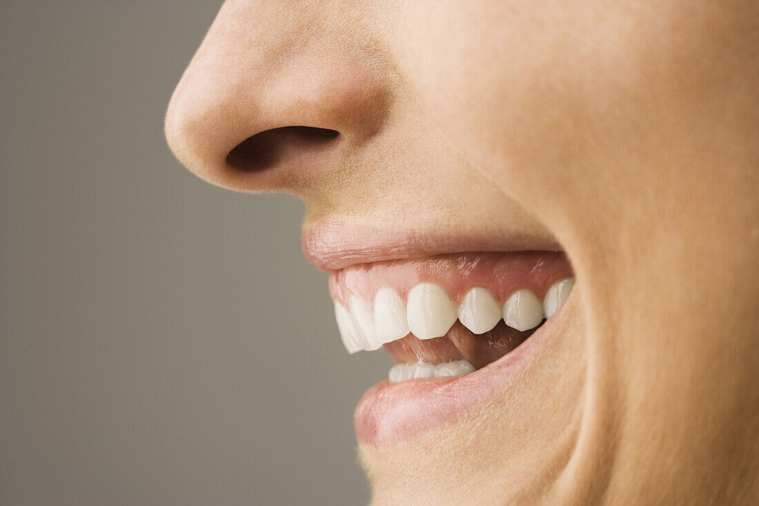 Woman laughing, side view