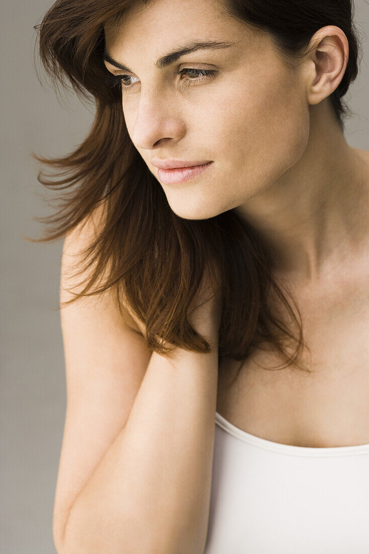 Young woman with hand in hair, portrait