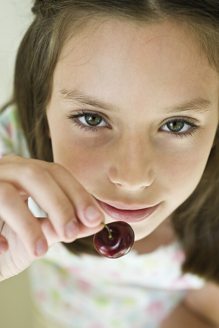Girl eating cherry