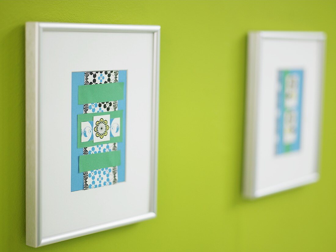 Framed paper craft on a green wall