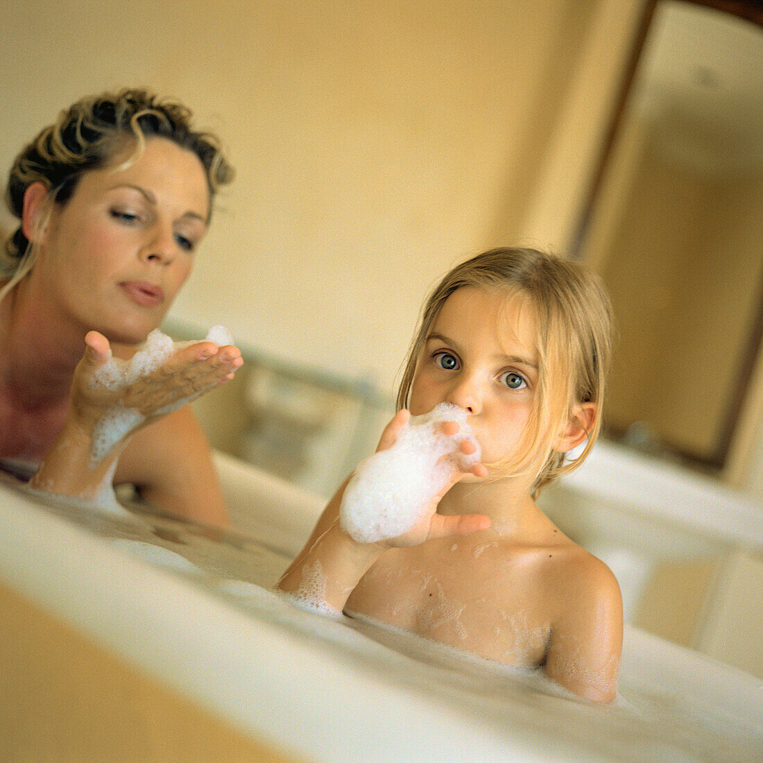 Woman and girl in bubble bath