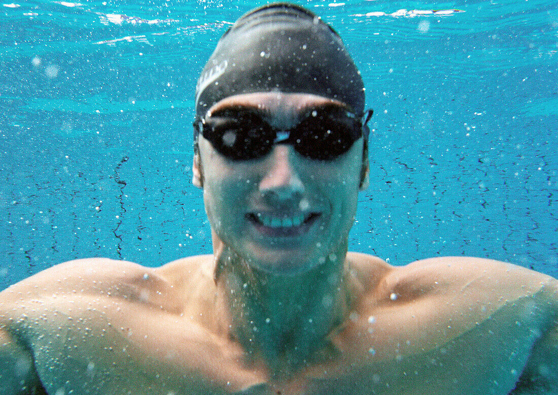 Man smiling underwater, underwater view.