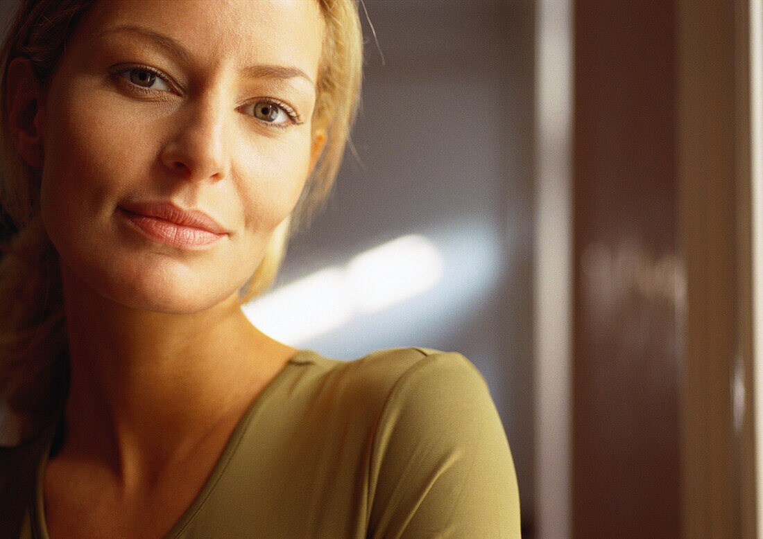 Woman looking at camera, close-up, portrait.