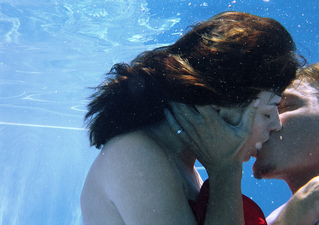 Couple kissing underwater, close-up