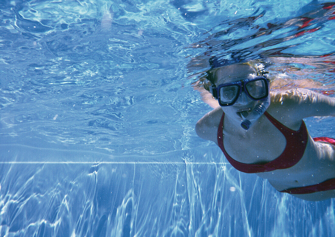 Young woman snorkeling in pool