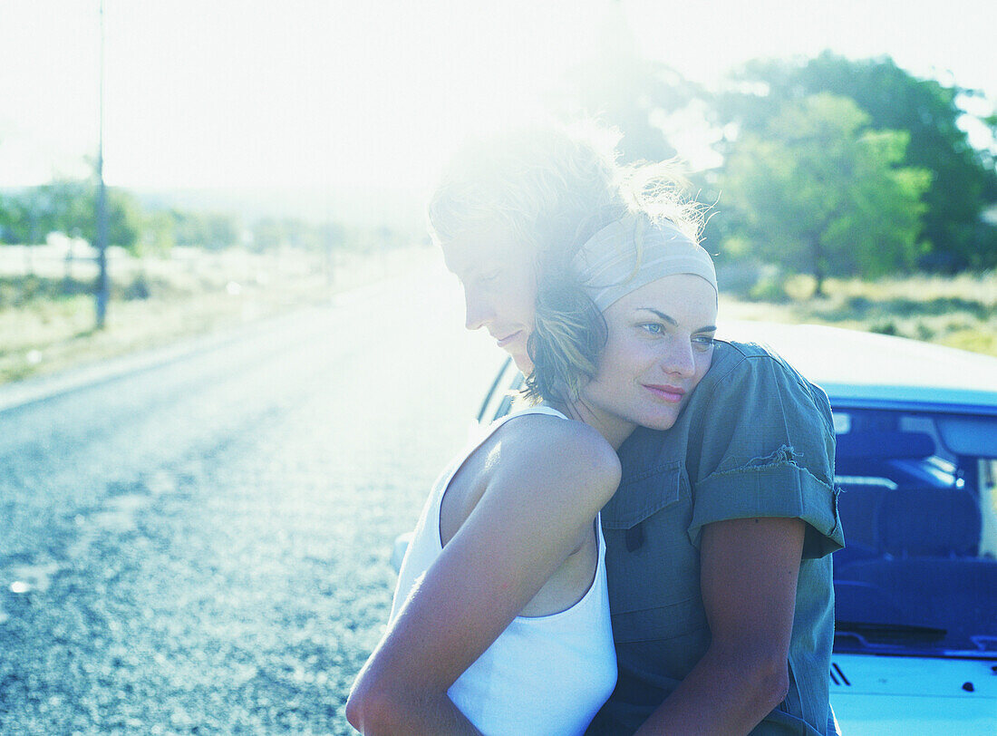 Couple hugging in road