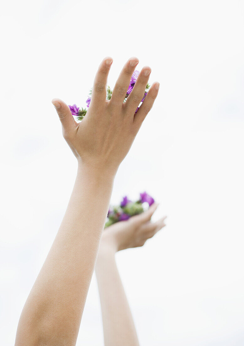 Woman's hands holding up flowers