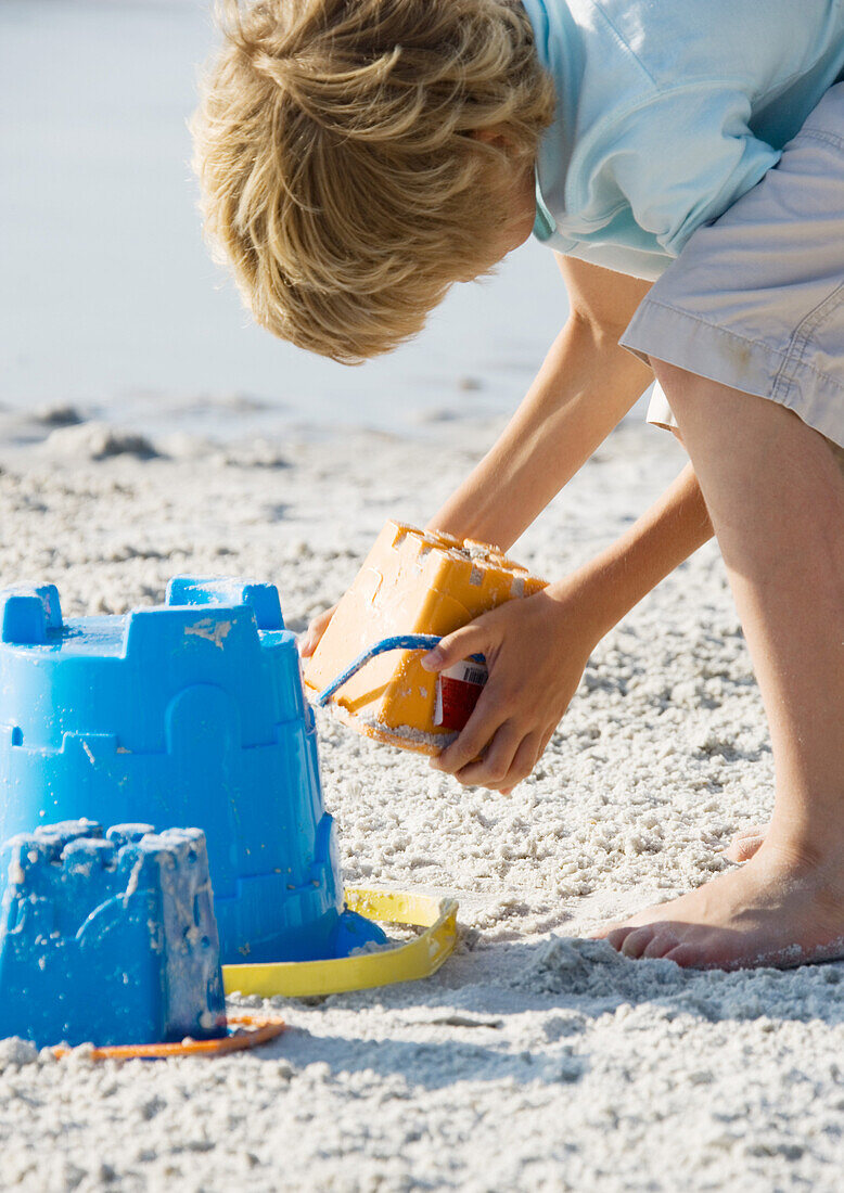 Child making sand castle