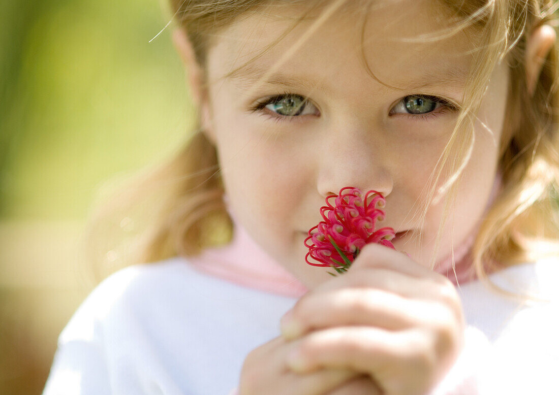 Girl smelling flower