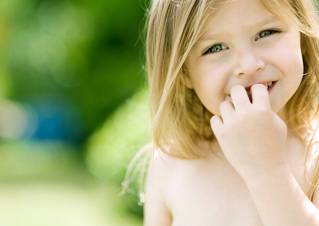 Little girl with fingers in front of mouth, portrait