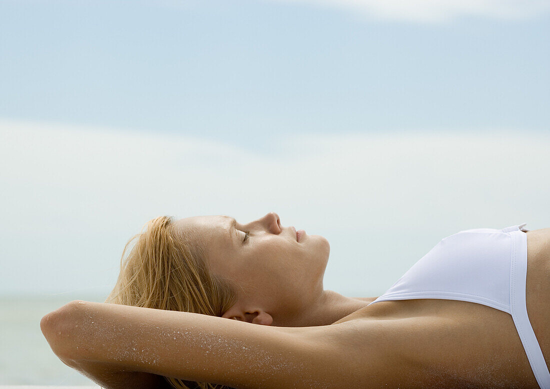 Woman sunbathing, profile