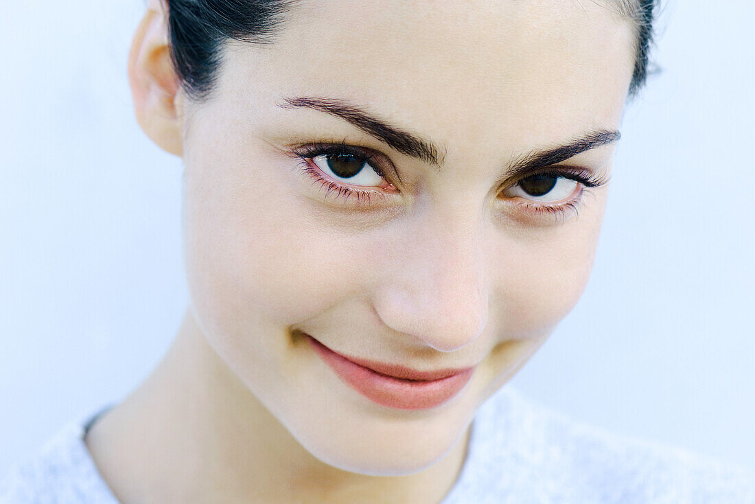 Woman smiling at camera, headshot, portrait