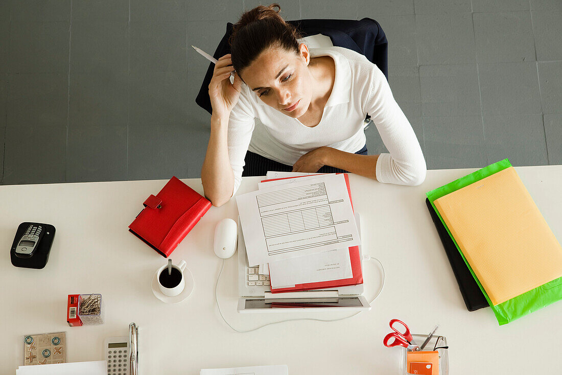 Businesswoman daydreaming at desk