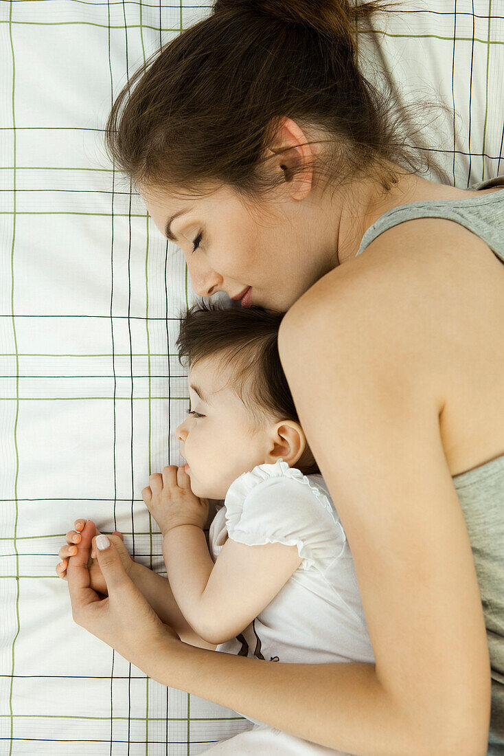 Mother and baby napping together