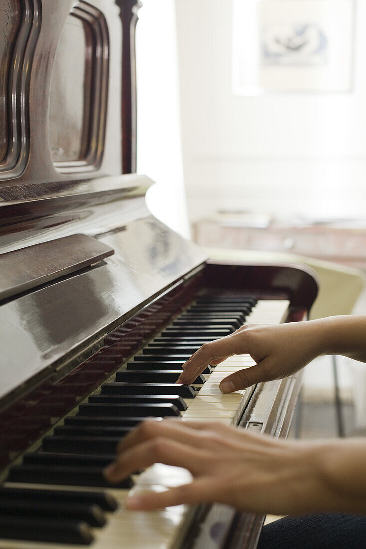 Woman's hands playing piano