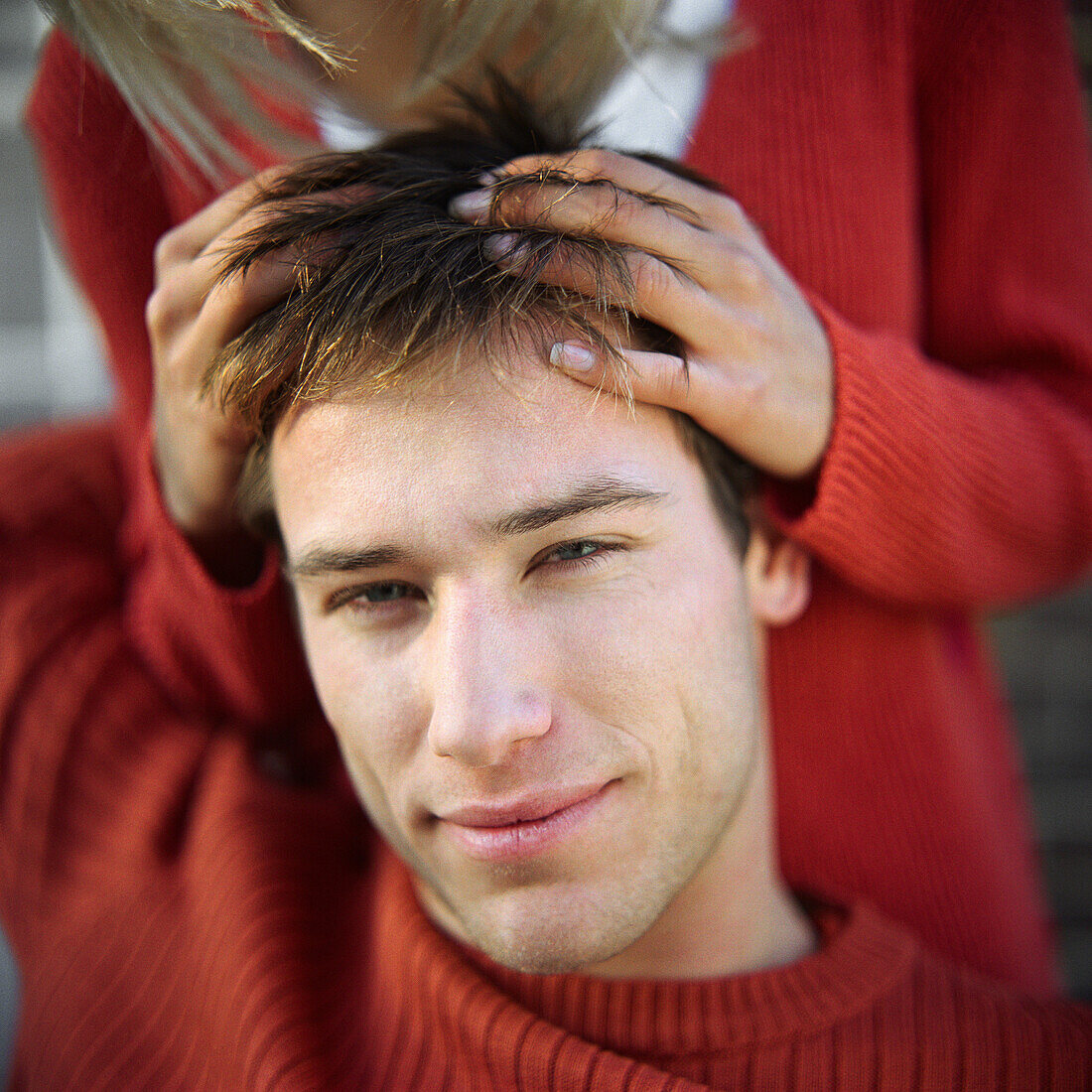 Woman playing with man's hair, portrait