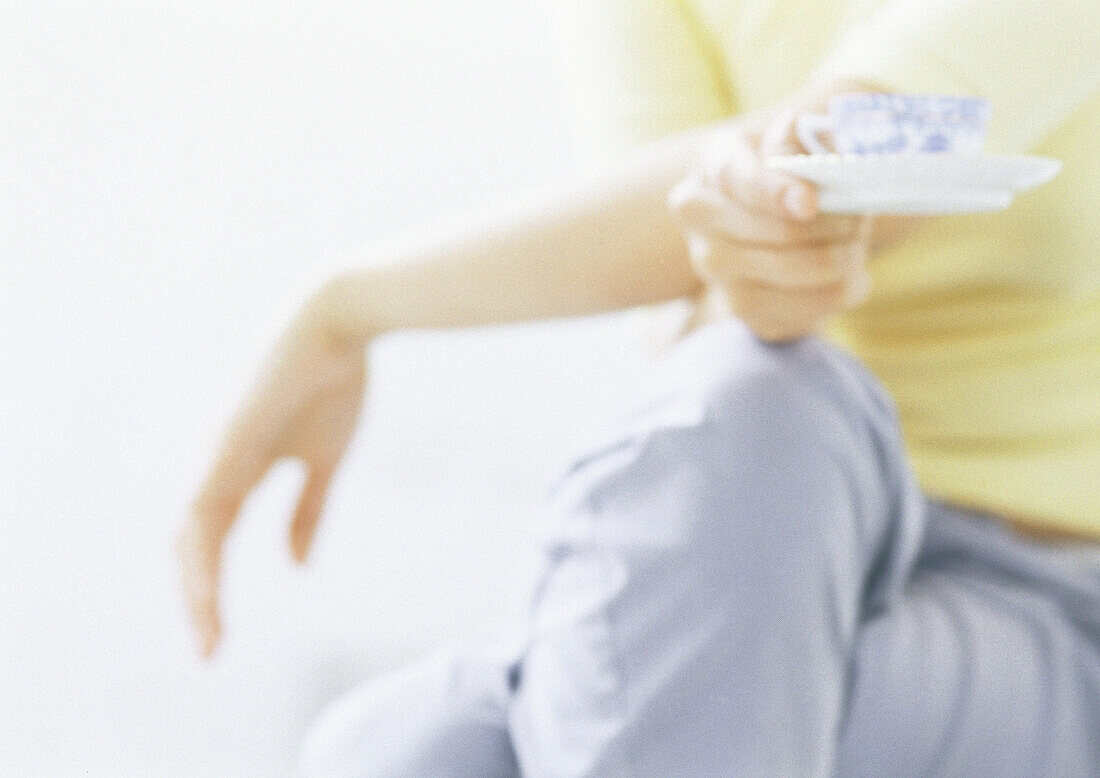 Woman holding teacup, close-up