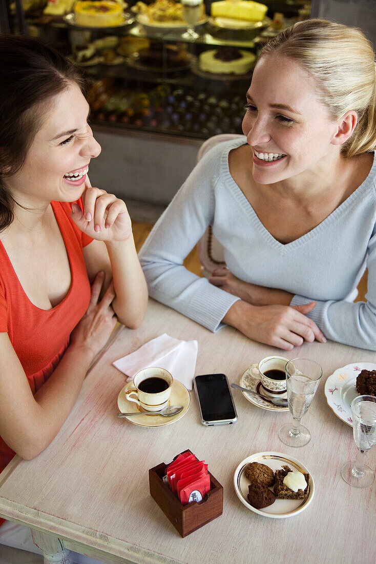 Female friends having coffee together at cafe