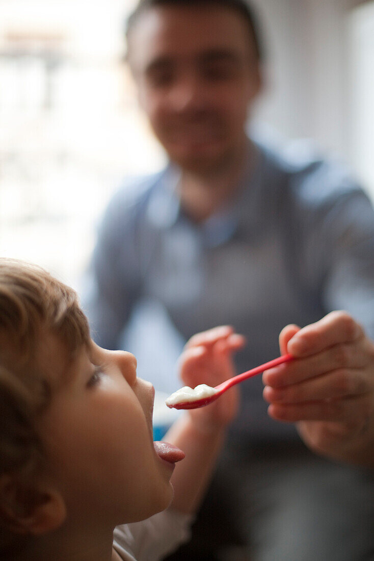 Toddler being fed spoonful of food