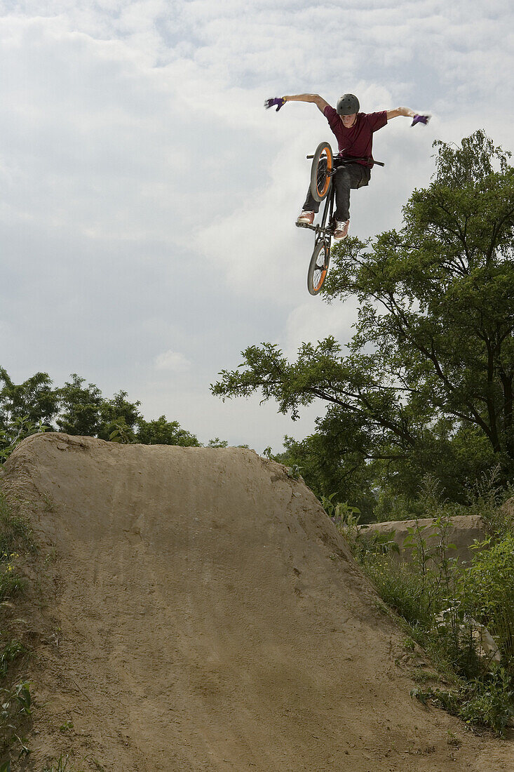 A BMX rider doing a stunt in mid air