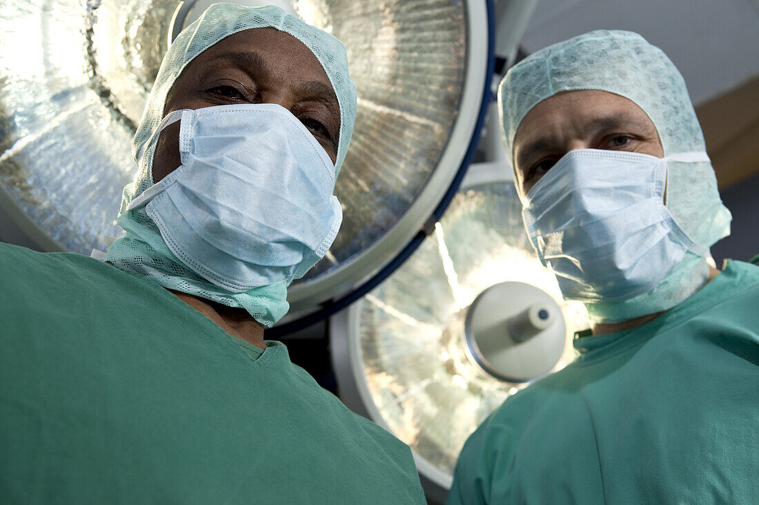 Two surgeons looking down at a patient, personal perspective