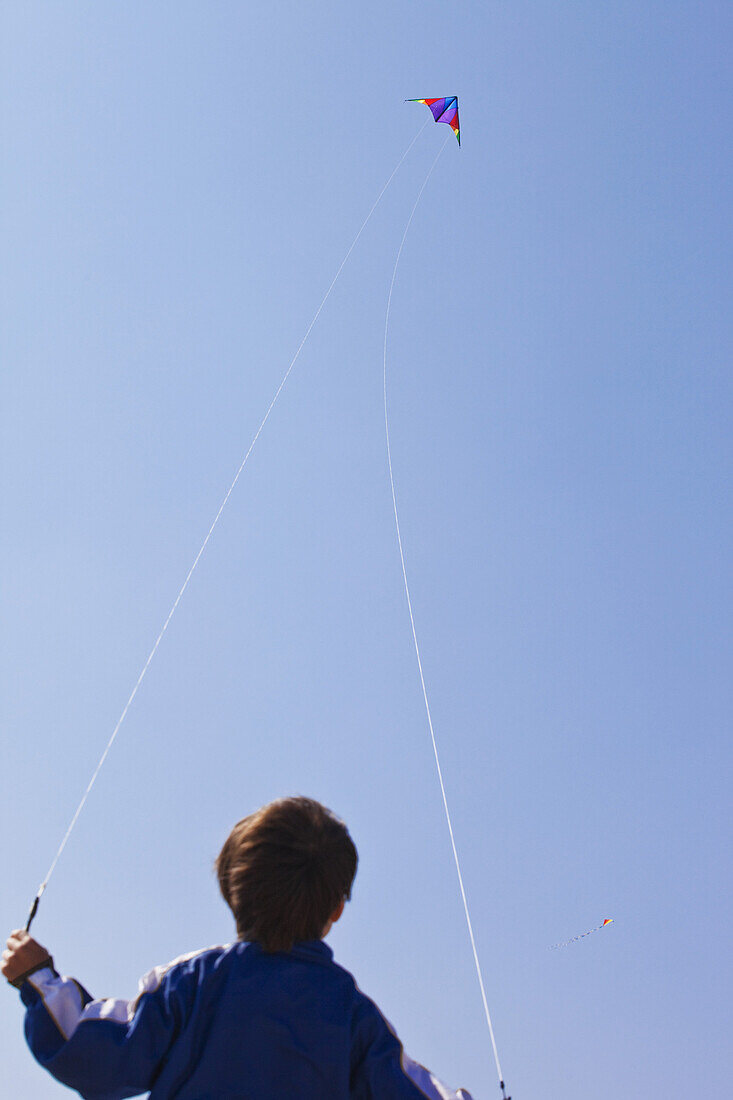 Rear view of a boy flying a kite
