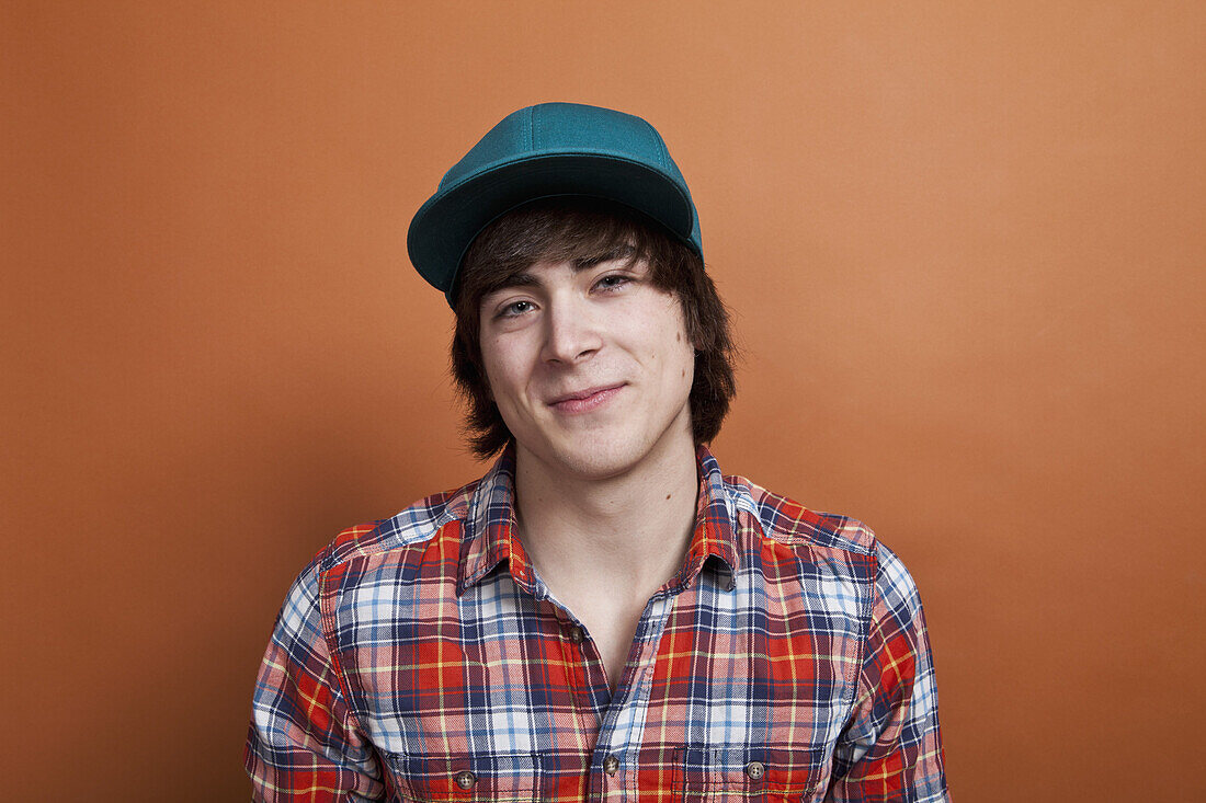 A teenage boy smiling, portrait, studio shot