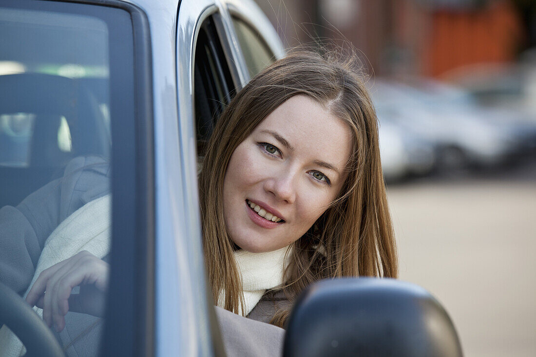Woman driver with head out of window